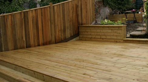 A stepping deck installed by Tate Fencing for a customer using grooved and reeded deck boards
