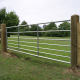 Galvanised metal field gate on timber posts