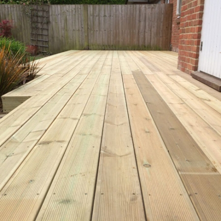 A patio area with a installed using our grooved and reeded softwood decking